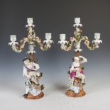 A pair of late 19th century Dresden porcelain encrusted four light candelabra, one modelled with