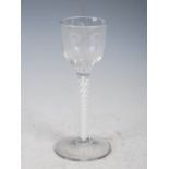 An 18th century opaque twist wine glass, the ogee bowl with engraved decoration of foliate spray and