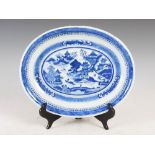 A Chinese porcelain blue and white oval shaped dish, Qing Dynasty, decorated with pavilions and