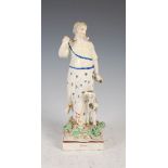 A 19th century Pearl ware figure group of Diana, modelled standing with a hound at her side, 21.