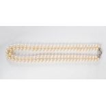 A cultured pearl double strand necklace with white metal and diamond set clasp, the clasp set with