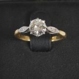 A mid 20th century yellow and white metal solitaire diamond ring, centred with a round brilliant cut