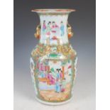 A Chinese porcelain famille rose Canton vase, Qing Dynasty, decorated with panels of figures divided