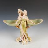 A Royal Dux Art Nouveau table centrepiece, modelled with two Art Nouveau maidens supporting two lily