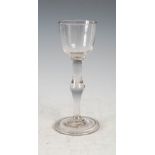 An 18th century wine glass, the ogee bowl on a clear ovoid knop stem and folded conical foot, 15.5cm