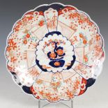 A Japanese Imari dish, late 19th/early 20th century, centred with a shaped circular panel