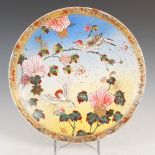 A Japanese Satsuma pottery dish, Meiji Period, decorated with flowering branches and two birds on