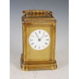 A late 19th/ early 20th century French brass repeating carriage clock striking on the half hour, the