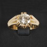 A yellow metal solitaire diamond ring, centred with a round brilliant cut diamond calculated to