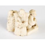 A Japanese ivory okimono figure group of four men, Meiji Period, signed, 5cm high x 6cm wide.