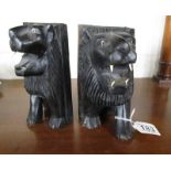 Pair of ebonised lion book ends