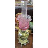 Brass oil lamp with Cranberry glass shade