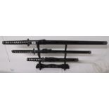 3 graduated Samurai swords on stand