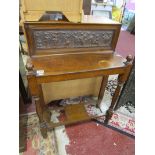Small hall table with ornately carved back panel