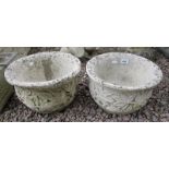 Pair of circular stone planters adorned with acanthus leaves
