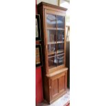 Pitch pine glazed bookcase on cupboard