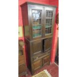 Tall oak cabinet with glazed doors