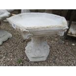 Gothic stone bird bath with hexagonal top