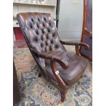 Button-back brown leather armchair