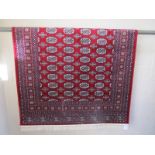 Red ground Bokhara rug - 2m x 1.4m