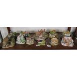 Shelf of boxed Lilliput Lane cottages