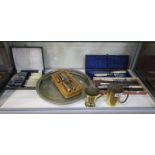 Shelf of flatware & 2 brass tankards