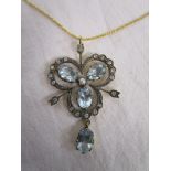 Diamond and blue topaz clover shaped pendant on chain