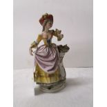 Continental figurine of lady in 18th century dress with crossed swords mark to base
