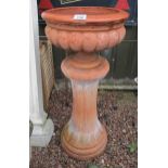 Terracotta planter on column plinth
