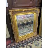 Bevelled glass mirror in ornate gilt frame