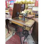 Early Singer sewing machine on treadle base