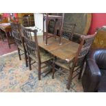 Jacobean style oak drawer leaf table and six chairs to include 2 carvers