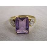 Gold ring set with large amethyst baguette