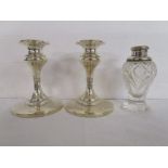 Pair of silver candlesticks and silver topped scent bottle