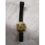 Gold ladies wrist watch on ribbon strap