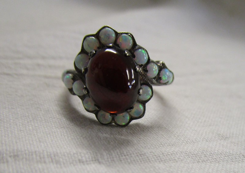 Cabochon garnet and water opal set ring