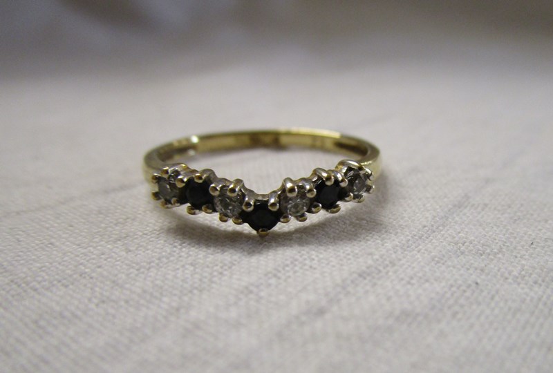 Gold sapphire and stone set wishbone ring