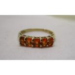 Gold ring set with fiery orange stones