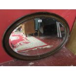 Oval oak framed bevelled glass mirror