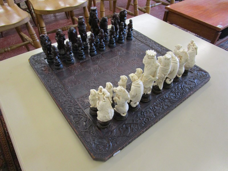 Chess set with ornate carved chess board