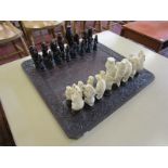 Chess set with ornate carved chess board