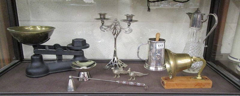 Shelf of collectables to include scales, claret jug & bell etc