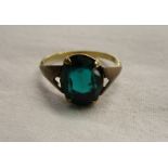 Gold ring set with green stone