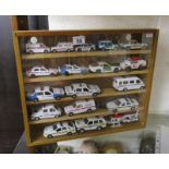 Collection of model police cars in display case