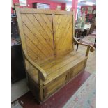 Large antique pine settle with cupboards to base (H: 156cm W: 152cm D: 76cm)
