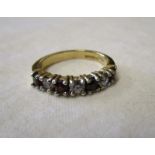 Gold garnet set half-hoop ring