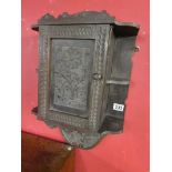 Carved ebonised wall cabinet