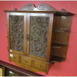 Carved mahogany hanging cabinet with drawers to base