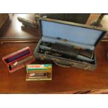 2 cased harmonicas and clarinet