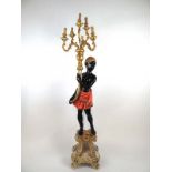 A modern poly-chrome blackamoor floor lamp, the figure holding a cornucopia with six light branches,